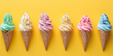 Colorful ice cream in waffle cones on yellow background, top view.