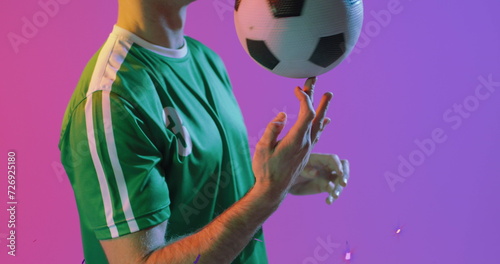 Image of caucasian male soccer player over confetti