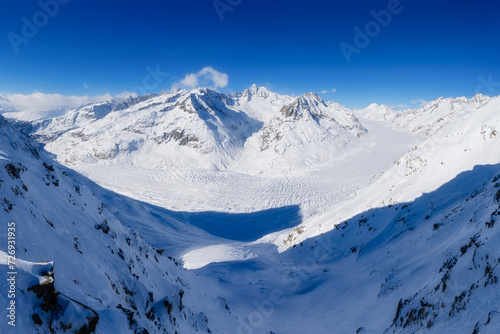 Aletsch glacier at the winter time. Switzerland. Winter mountain landscape. Wallpaper or background. Cold weather and frost. High rocks and snow. View of mountains.