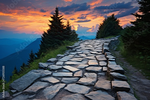 Spectacular view of serene mountain road at glowing sunset