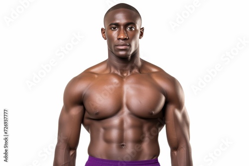 Muscular afro american fitness model with well defined abdominal muscles in stylish purple top