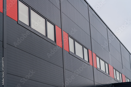 Grey sandwich panel warehouse with red design elements photo