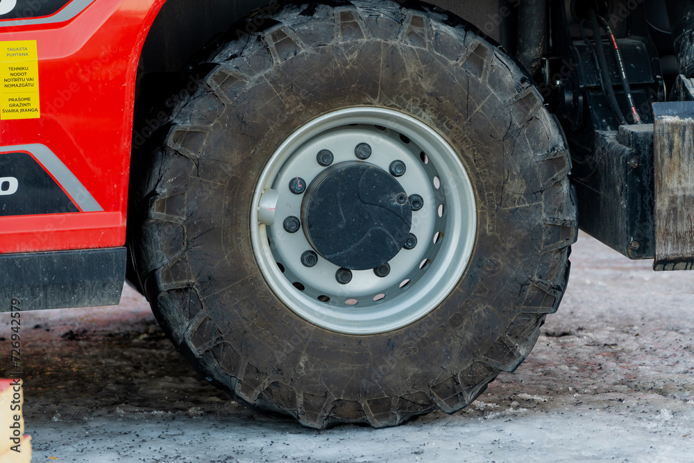 Heavy machinery construction truck big tyres in winter on construction yard Heavy machinery construction truck big tyres in winter on construction yard