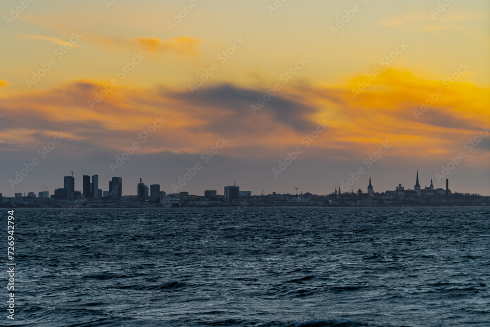 Beautiful orange clouds skies above the city of Tallinn in Estonia