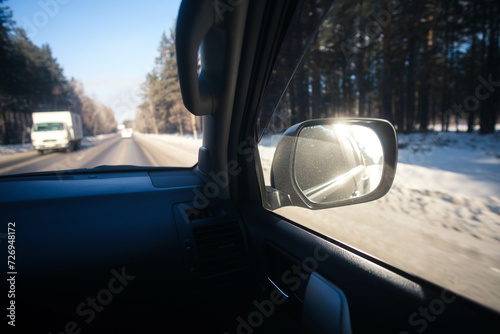 Fototapeta Naklejka Na Ścianę i Meble -  Cars driving along the road, view inside the car