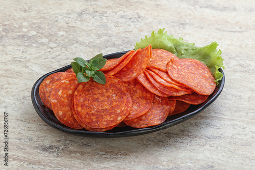 Sliced pepperoni sausage in the bowl