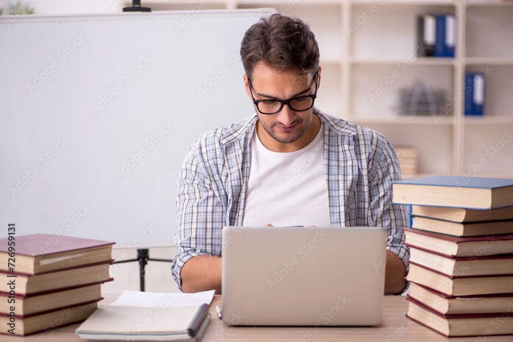 Young male student preparing for exams in the classroom Young male student preparing for exams in the classroom