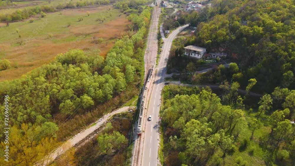 Drone shot following a train in Virpazar, Montenegro changing tracks. Drone shot following a train in Virpazar, Montenegro changing tracks.