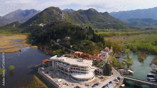 Drone shot flying over the village of Virpazar, Montenegro towards the Besac Fortress. photo
