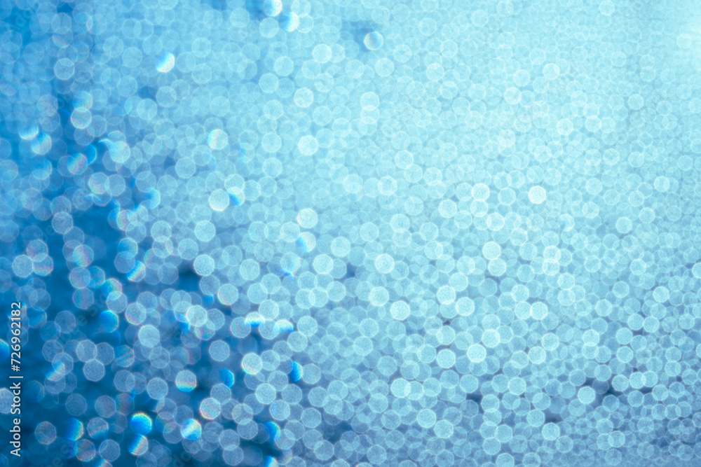 Bokeh in blue and light blue colors. Background for design, postcard.