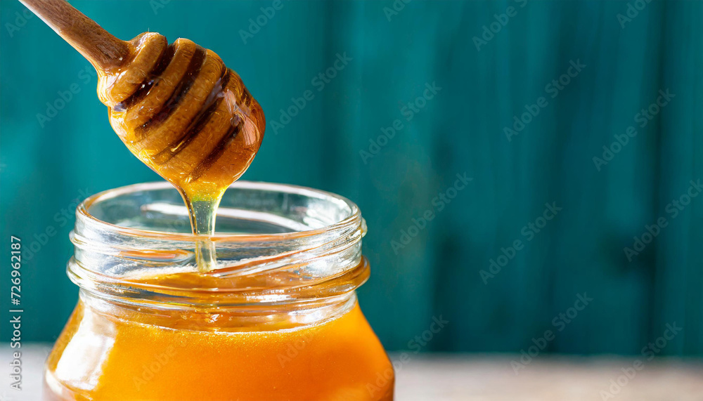 Honey sauce splash, honeysauce flowing, honey jar, copyspace on the side Honey sauce splash, honeysauce flowing, honey jar, copyspace on the side