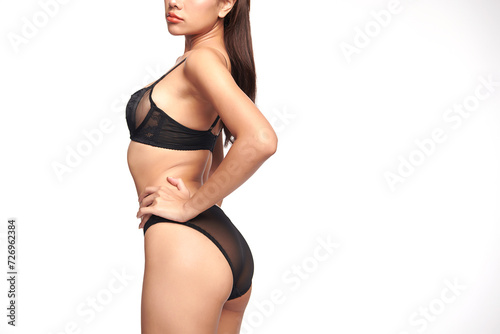 Confident beautiful young asian woman posing in black lingerie on white background, Perfect body,