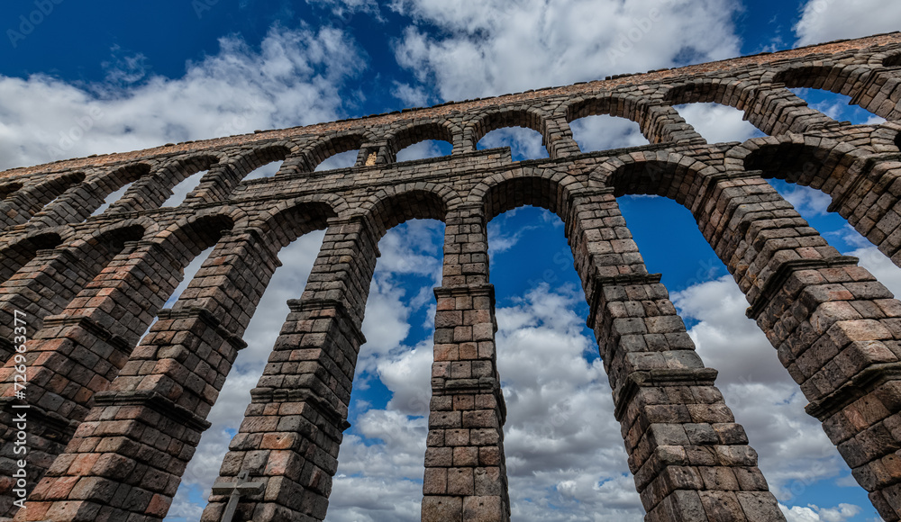 Ancient Roman aqueduct on Plaza del Azoguejo square and old building towns in Segovia, Spain Ancient Roman aqueduct on Plaza del Azoguejo square and old building towns in Segovia, Spain