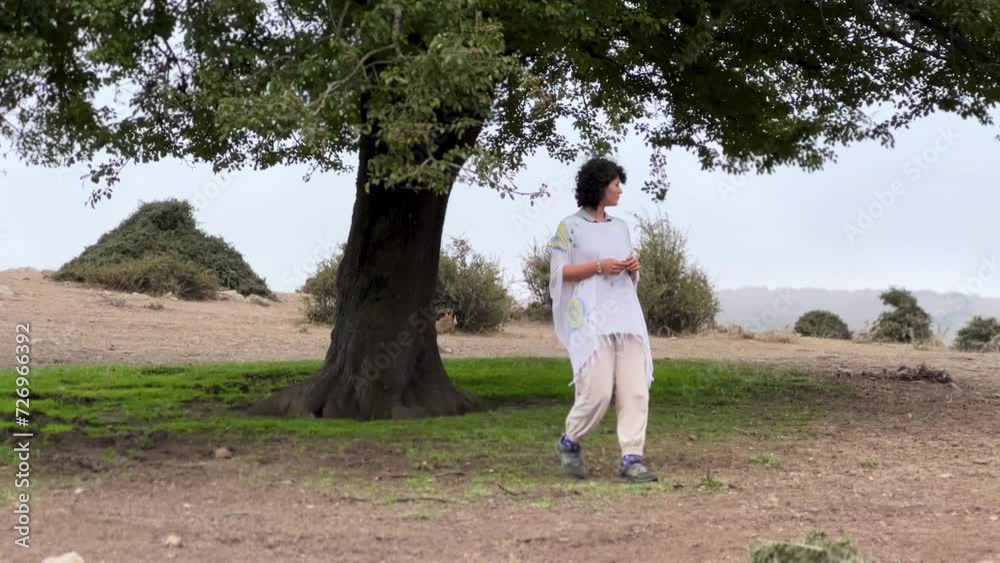 a white dressed Persian woman Iranian people walking in nature hiking adventure in mountain forest Hyrcanian nature landscape alone single mature tree hazy day fog in highland height Iran Gilan people a white dressed Persian woman Iranian people walking in nature hiking adventure in mountain forest Hyrcanian nature landscape alone single mature tree hazy day fog in highland height Iran Gilan people