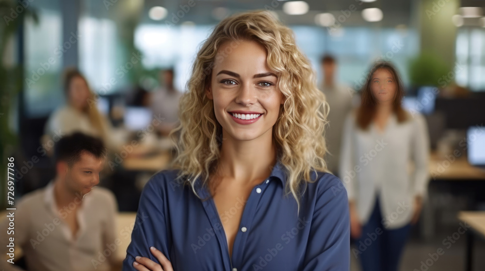 Fototapeta premium Attractive and confident smiling professional woman posing in her business office with her colleagues