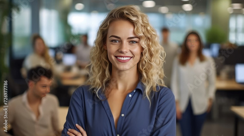 Attractive and confident smiling professional woman posing in her business office with her colleagues