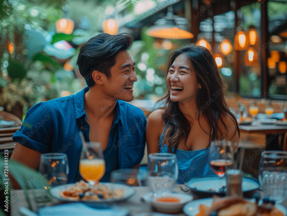 A man and woman smile at each other across a restaurant table having a luxury dinner A man and woman smile at each other across a restaurant table having a luxury dinner