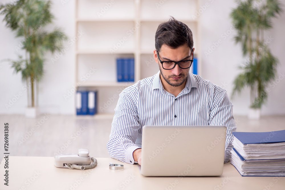 Young male employee working in the office