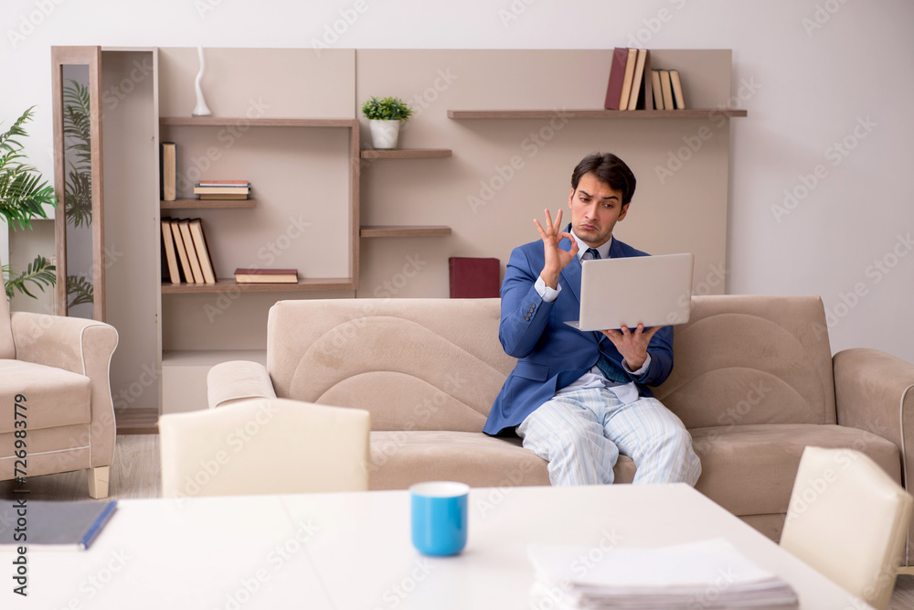 Young male employee working from home during pandemic Young male employee working from home during pandemic