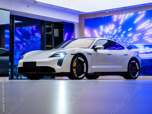 White car in studio with lighing in background