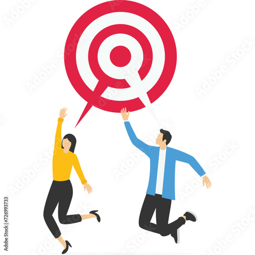 Teamwork aiming on the same target, Business partner talking about work on the circular dartboard target.

