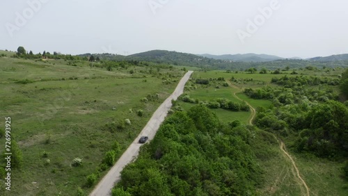 Drone following a vehicle movong on a highways in the highlands going to the place of Tsarichina Hole or Area 51, known for its paranormal sightings in Bulgaria. photo