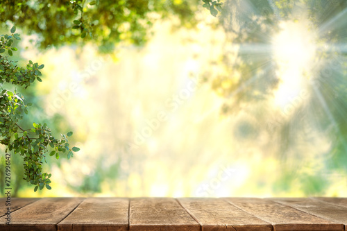 Empty wooden table on nature outdoor for free space for product. Spring beautiful background