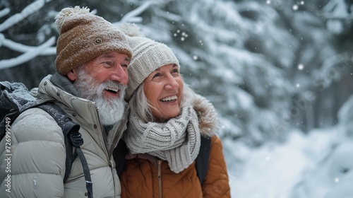 A happily laughing couple of retirees relish the winter forest, with snow falling and trees in the backdrop, Generative AI. © Electro Unicorn