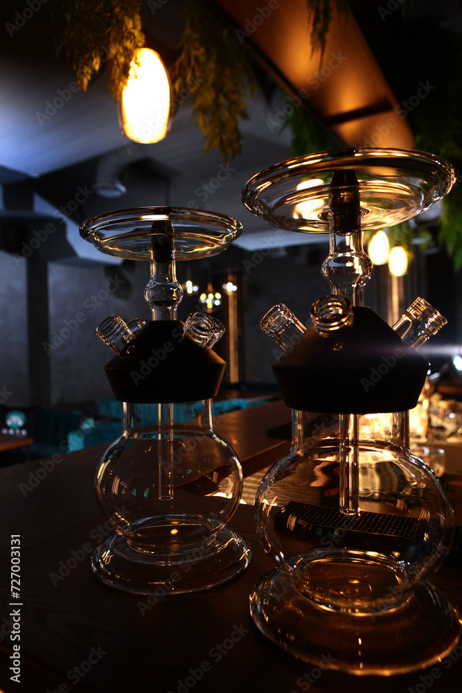 Obraz premium Hookah flasks. Hookah smoking. The flasks are on the bar counter in the lounge bar. Hookah room.