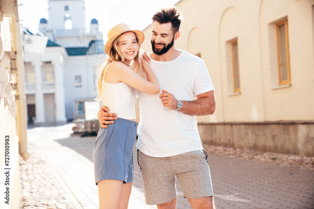 Smiling beautiful woman and her handsome boyfriend. Woman in casual summer clothes. Happy cheerful family. Female having fun. Couple posing in street at sunny day. Having tender moments. In sunglasses
