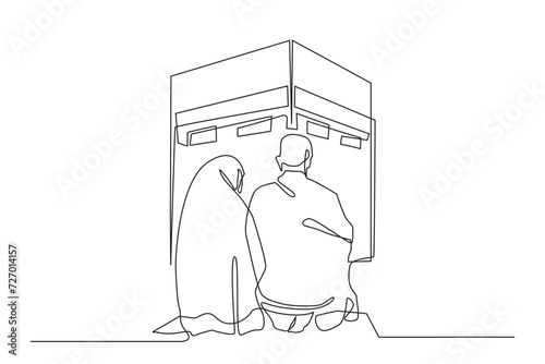 continuous line of man and woman praying at the kaaba.single line art of a muslim couple praying in front of the kaaba during the hajj pilgrimage