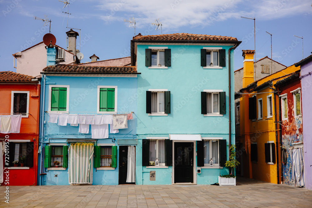 Colorful houses with laundry hanging from the windows in Burano, Italy