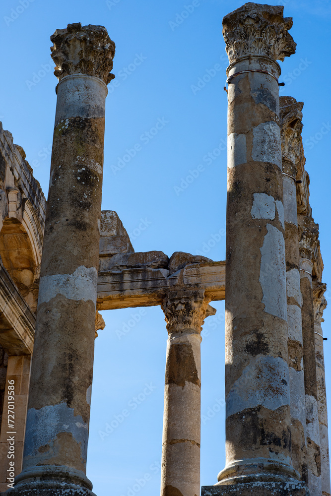 Low-angle view of Roman columns against the sky in the ancient Roman town of Djemila, Setif, Algeria.