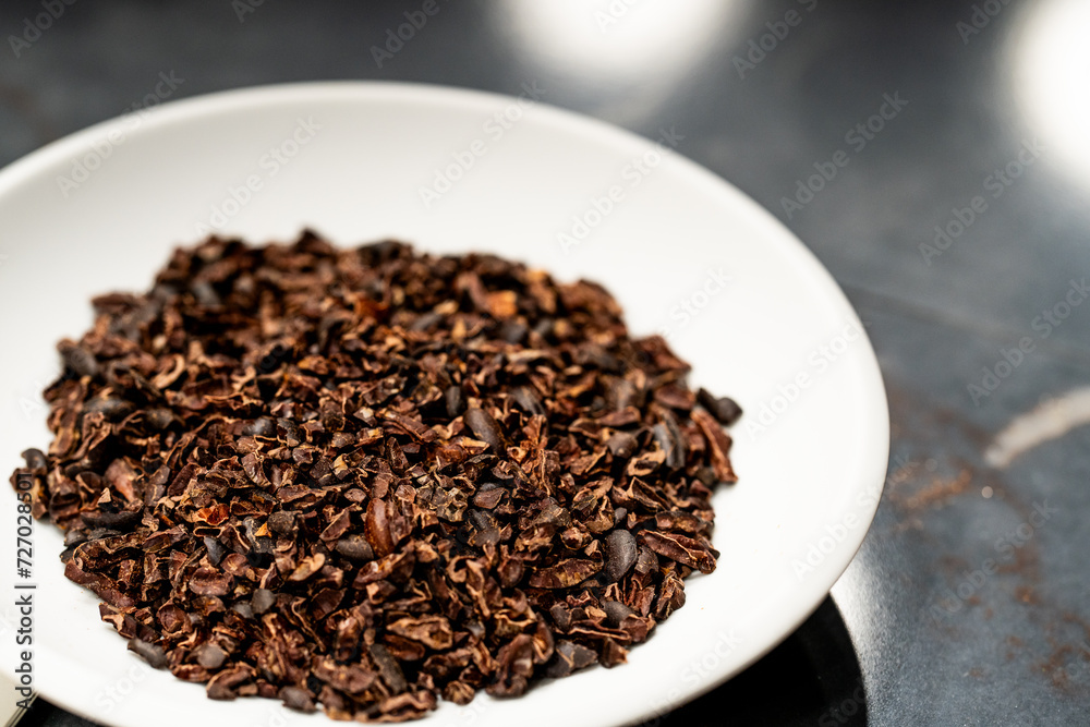 natural cocoa chips displayed on a white plate natural cocoa chips displayed on a white plate
