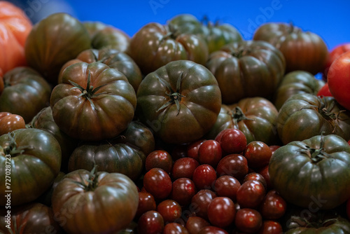 mix of different types of organic tomatoes such as raf tomato and black cherry tomato