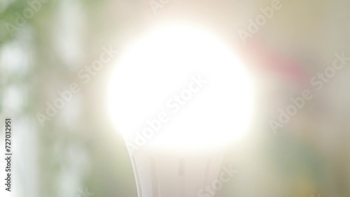 Turn On the Light in Room, Saving Concept Using Led Bulb in Energy Industry Crisis, Girl Screws a Led Light Bulb in Socket photo