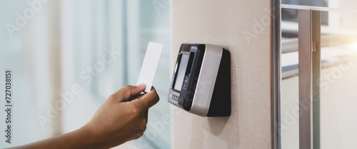Proximity card door unlock, Hand security man using ID card on fingerprint scan reader access control system for identity verification to open the door or for security safety or check attendance.