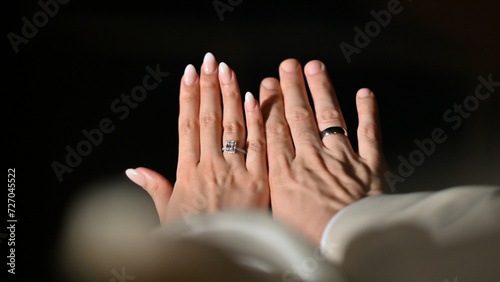 Bride and groom holding hands in the skyline black background. Wedding, engagenment, love, family