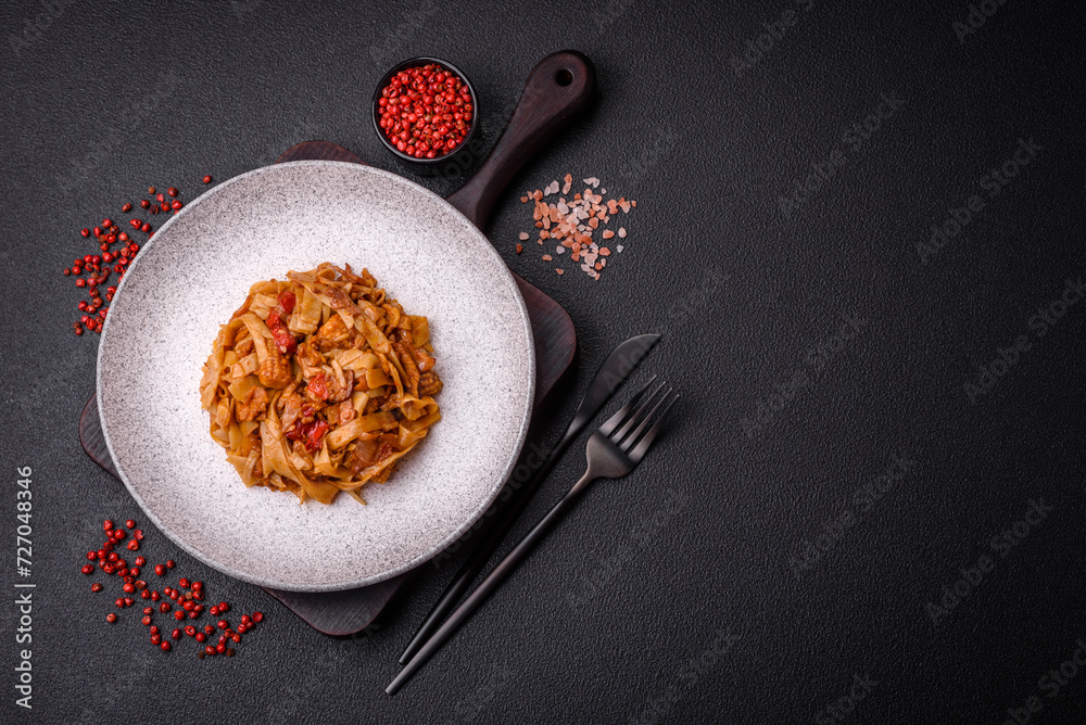Delicious asian udon dish with vegetables, mushrooms, salt and spices