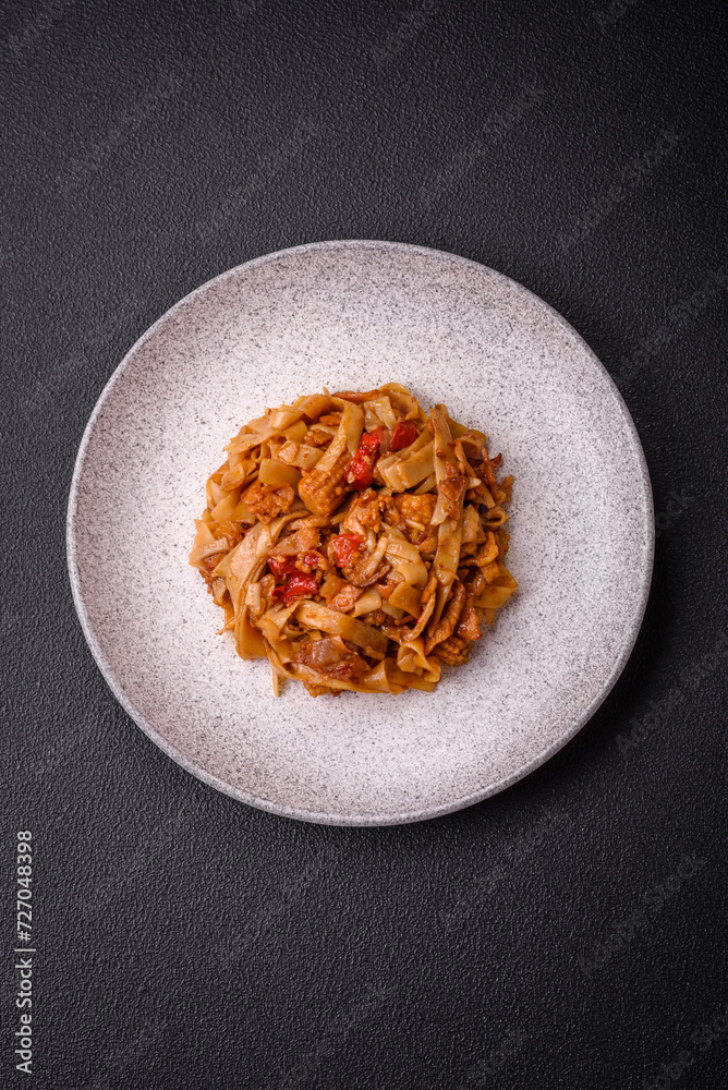 Delicious asian udon dish with vegetables, mushrooms, salt and spices Delicious asian udon dish with vegetables, mushrooms, salt and spices