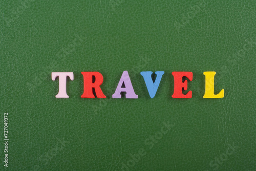 TRAVEL word on green background composed from colorful abc alphabet block wooden letters, copy space for ad text. Learning english concept. photo