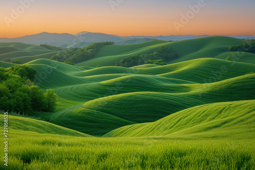 Aerial view of green fields over hills at twilight
