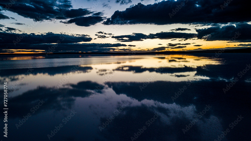 Fototapeta premium Landscape beautiful sunset black sky salt lake.reflection of clouds in still water