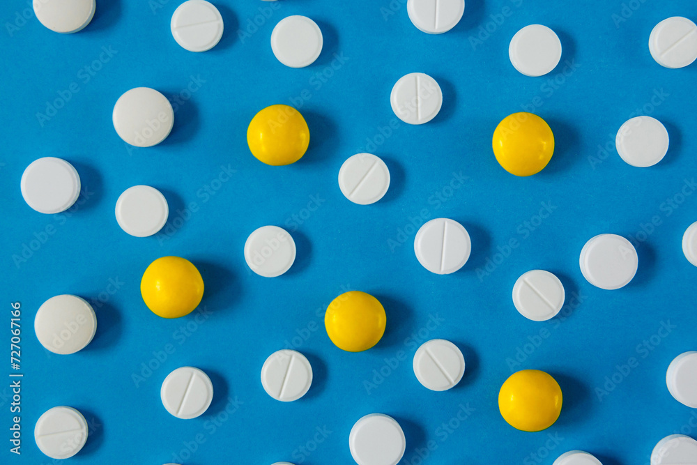 many white and red pills on a blue background many white and red pills on a blue background