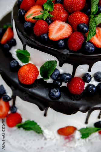 Fototapeta Naklejka Na Ścianę i Meble -  wedding cake with strawberries chocolate and blueberries