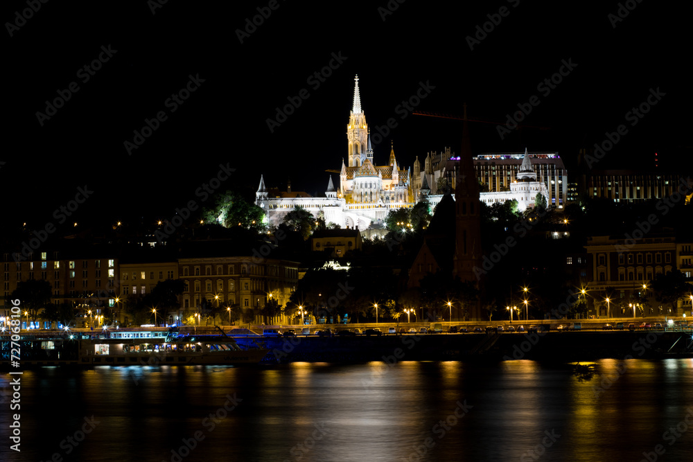 Fototapeta premium A tall castle on a hill. Night Budapest. Beautiful panorama of a big city in Europe. European city Budapest. Sights and attractions of Hungary.
