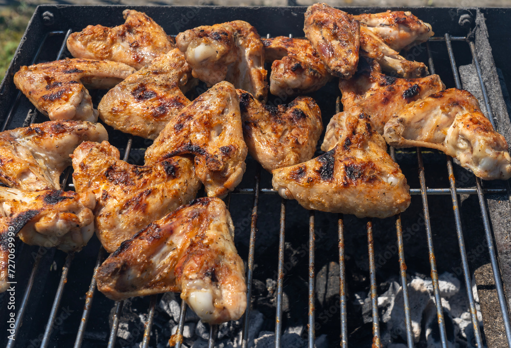 Tasty chicken wings cooked on the grill. Summer and holiday time. Delicious food