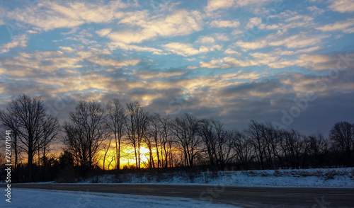 Sunrise on a country road in the winter.