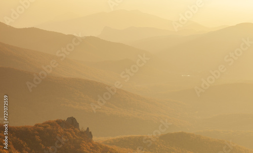 Landscape. Mountain slopes in the mist at sunset