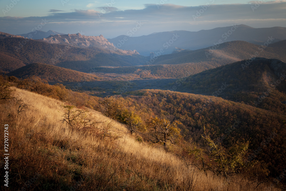 Autumn forest and mountains at sunset